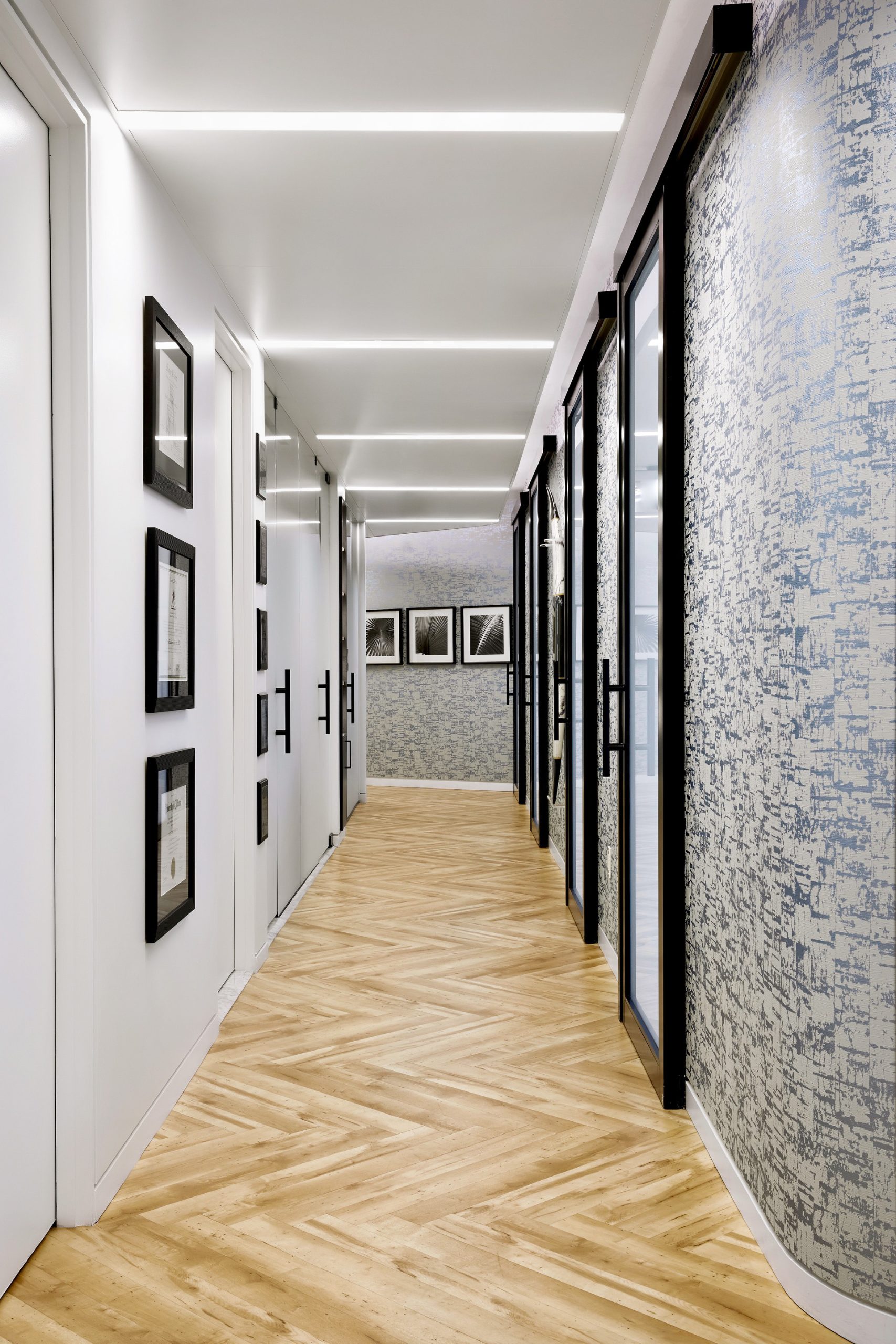 Modern hallway with elegant lighting and framed artwork