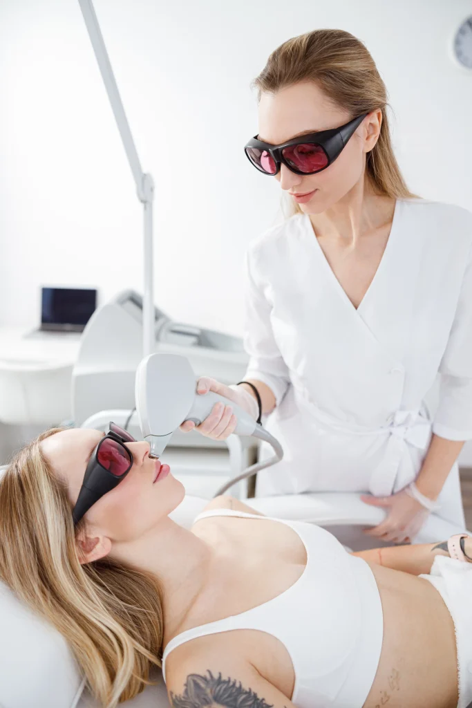 Halo Laser Treatment session in progress with esthetician using laser device on woman's face